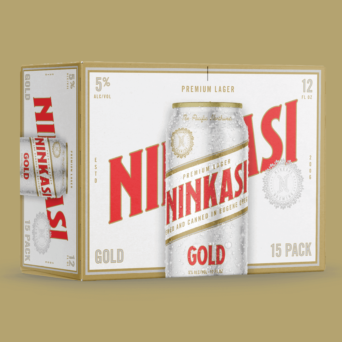 The image shows a 15-pack box of Ninkasi Gold Premium Lager. The packaging is primarily an off-white color with bold red and gold accents. The Ninkasi logo is prominently displayed in red, with "Gold" written underneath in a large, elegant script. A tagline "The Pacific Northwest" is visible above the logo, emphasizing the beer's regional roots. There's a depiction of a beer can in the center, with water droplets on it, indicating it's chilled. The beer is described as "PREMIUM LAGER" and "BREWED AND CANNED IN EUGENE, OREGON" as per the text below the can image. The alcohol by volume is noted as "5%" and the can size as "12 FL OZ". The background has a slight texture, giving it a premium feel, and the left side of the image subtly shows "15 PACK" indicating the quantity within the box.