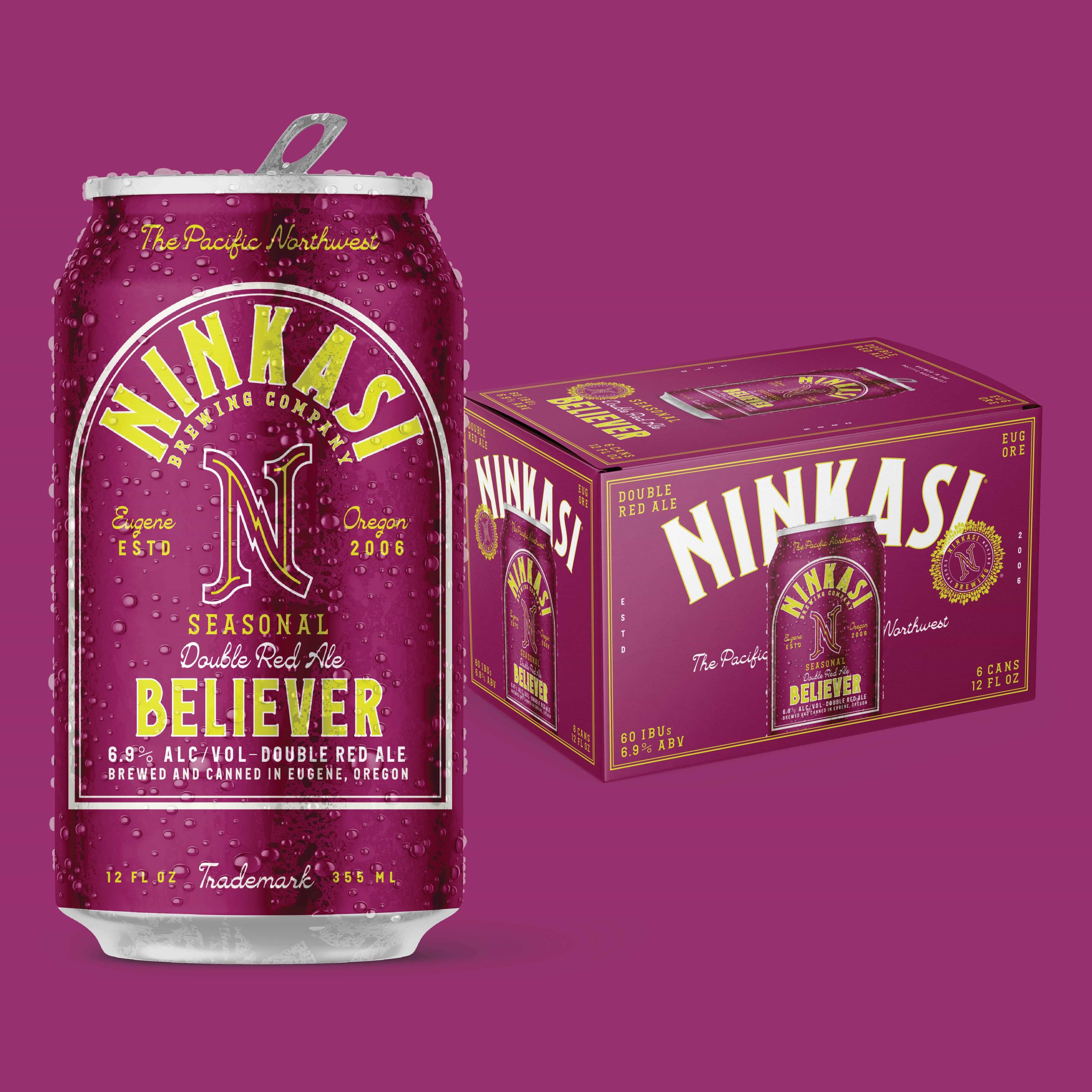 Ninkasi Believer double red ale can with condensation beside magenta six-pack box on purple background